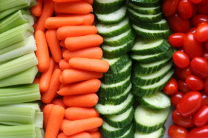 Celery, carrots, sliced cucumbers, and cherry tomatoes all lined up